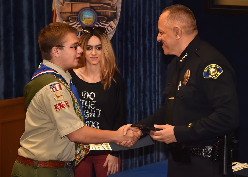 Jay Edward Jones, twelfth grade student from Esperanza High School, receives his Do the Right Thing award from Anaheim Police Chief Raul Quezada and Aviella Winder, behind them. Photo by Steven Georges/Behind the Badge OC