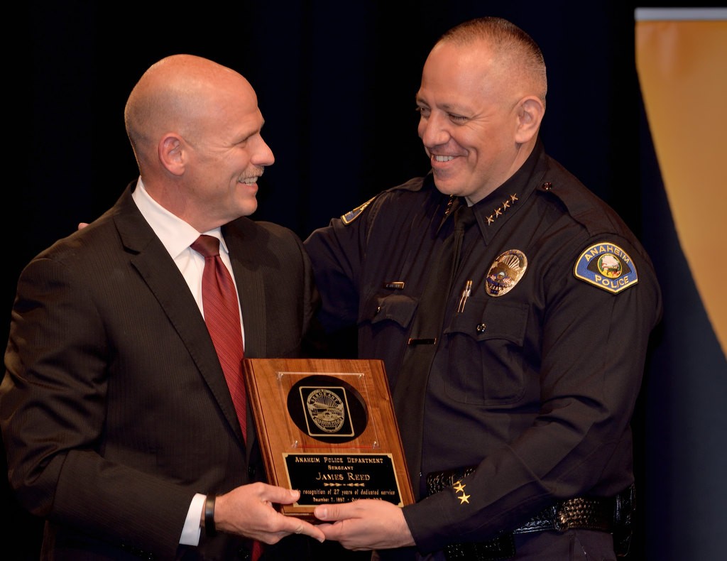 APD Sgt. Jim Reed, left, receives recognition for 27 years of service from Anaheim Police Chief Raul Quezada. Photo by Steven Georges/Behind the Badge OC