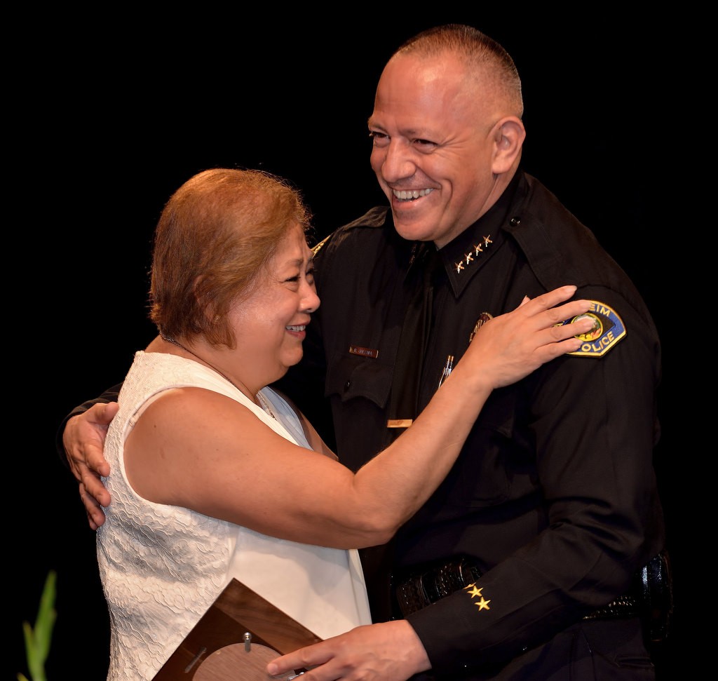 Office Specialist Evelyna Lazo gets a hug from Anaheim Police Chief Raul Quezada as she receives recognition for 10 years of service. Photo by Steven Georges/Behind the Badge OC