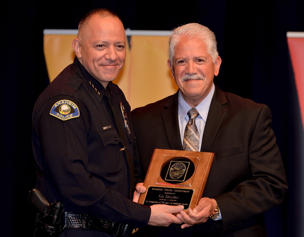 APD Sgt. Ed DeLeon, right, receives recognition for 23 years of service from Anaheim Police Chief Raul Quezada. Photo by Steven Georges/Behind the Badge OC