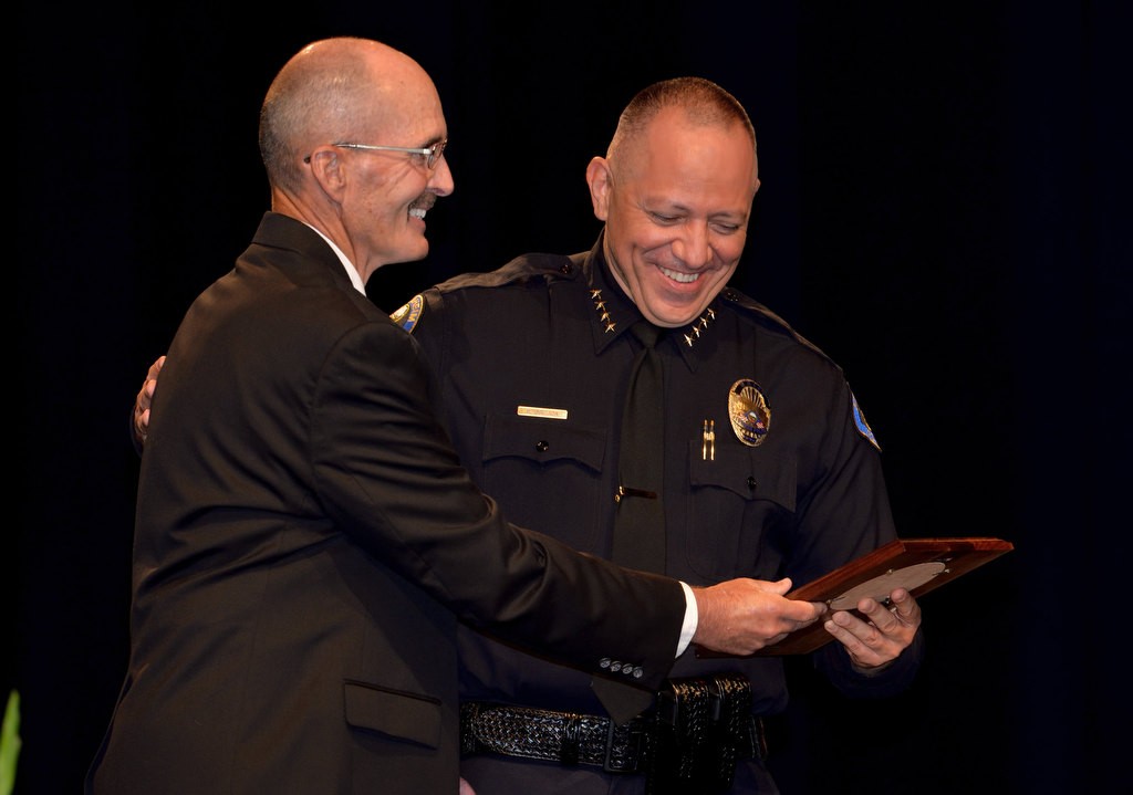 APD Investigator Dave Cyprien, left, receives recognition for 34 years of service from Anaheim Police Chief Raul Quezada. Photo by Steven Georges/Behind the Badge OC