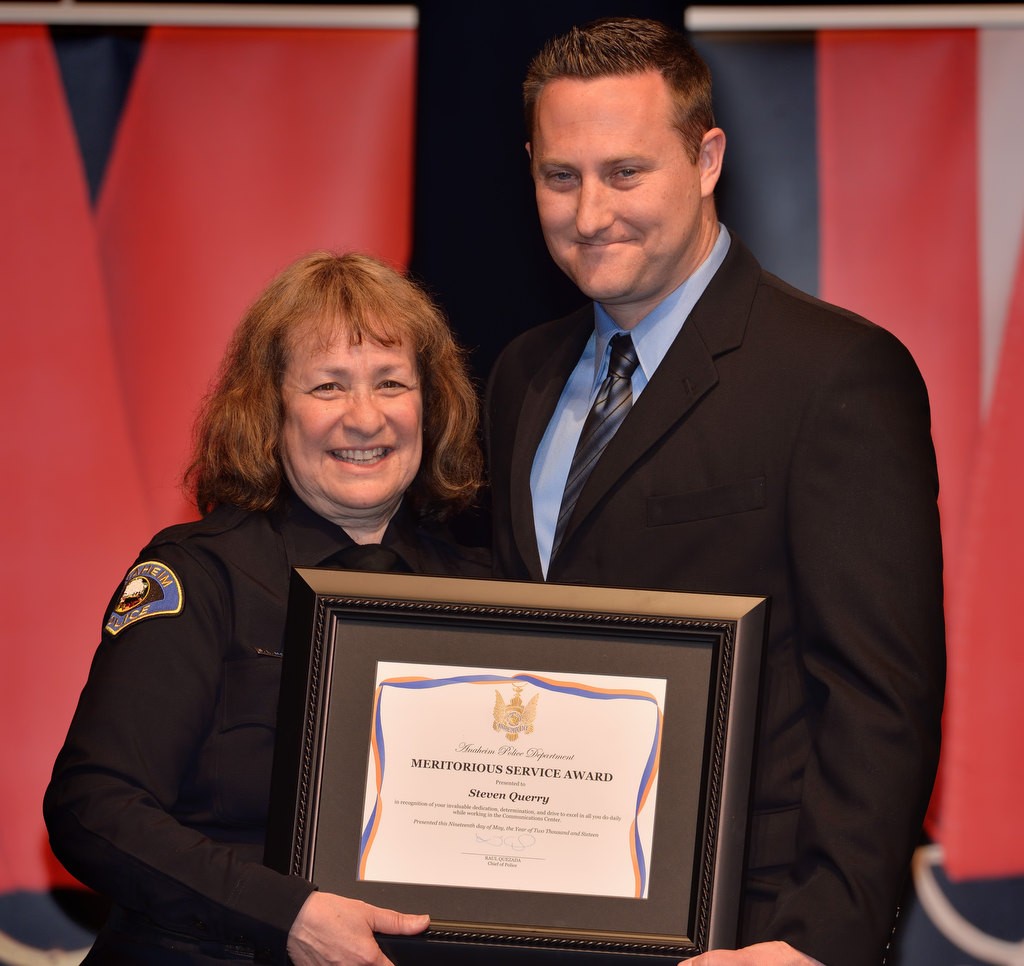 Dispatch Supervisor Steven Querry receives the Meritorious Service Award from Commander Shelley McKerren. Photo by Steven Georges/Behind the Badge OC