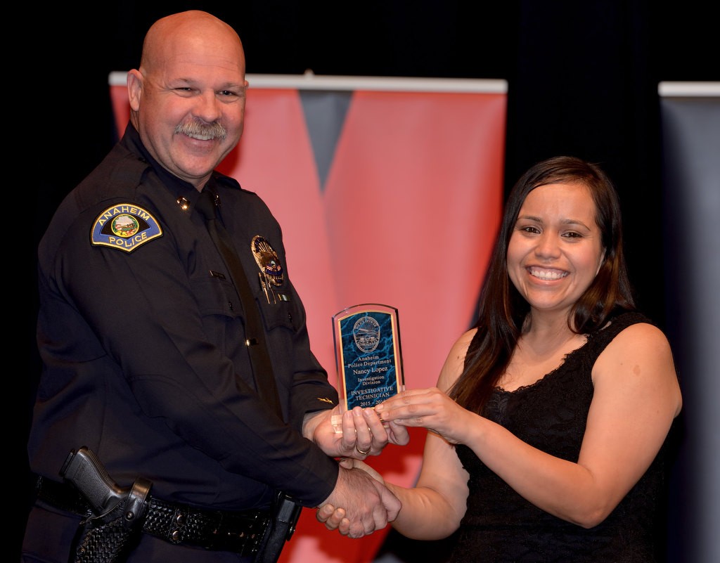Civilian Investigator Nancy Lopez, right, receives the Investigations Division Employee of the Year award from APD Capt. Steve Davis. Photo by Steven Georges/Behind the Badge OC