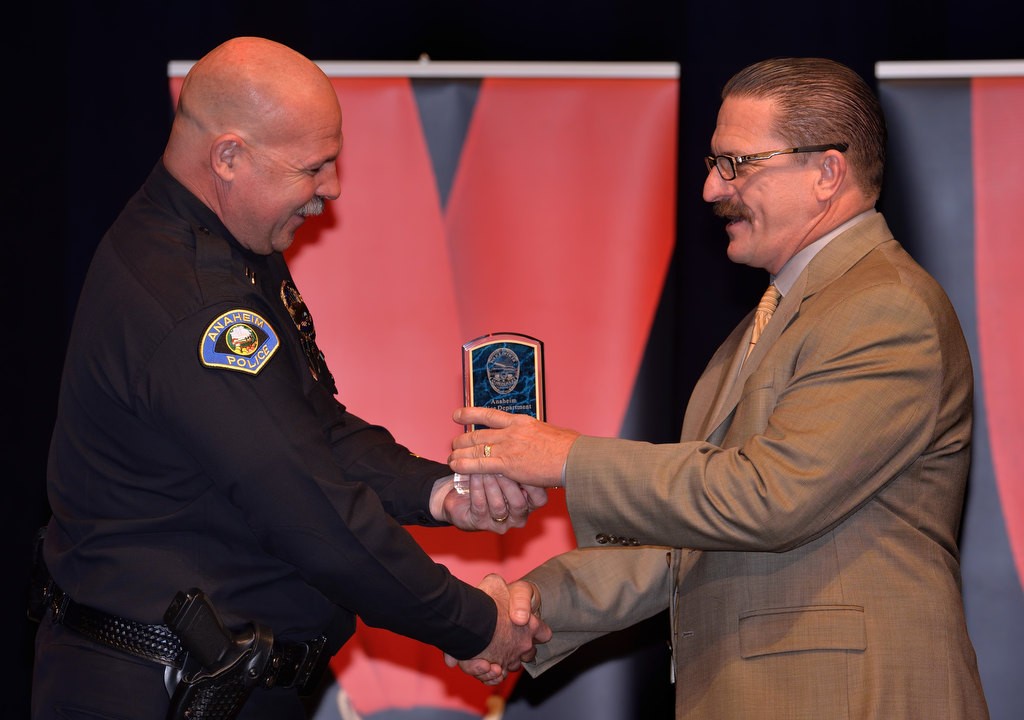 Dave Hermann, right, receives the Investigations Division Detective of the Year award from APD Capt. Steve Davis. Photo by Steven Georges/Behind the Badge OC
