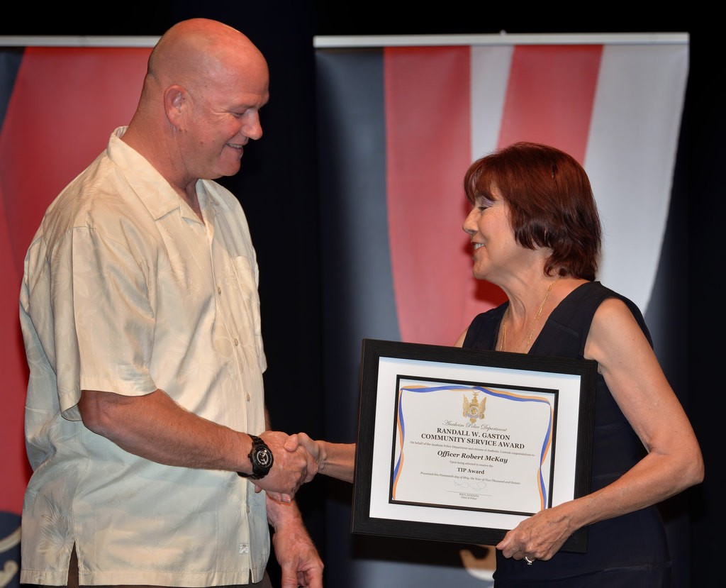 APD Officer Robert McKay receives a Community Service TIP (Trauma Intervention Programs) award from Anaheim Mayor Pro Tem Lucille Kring. Photo by Steven Georges/Behind the Badge OC