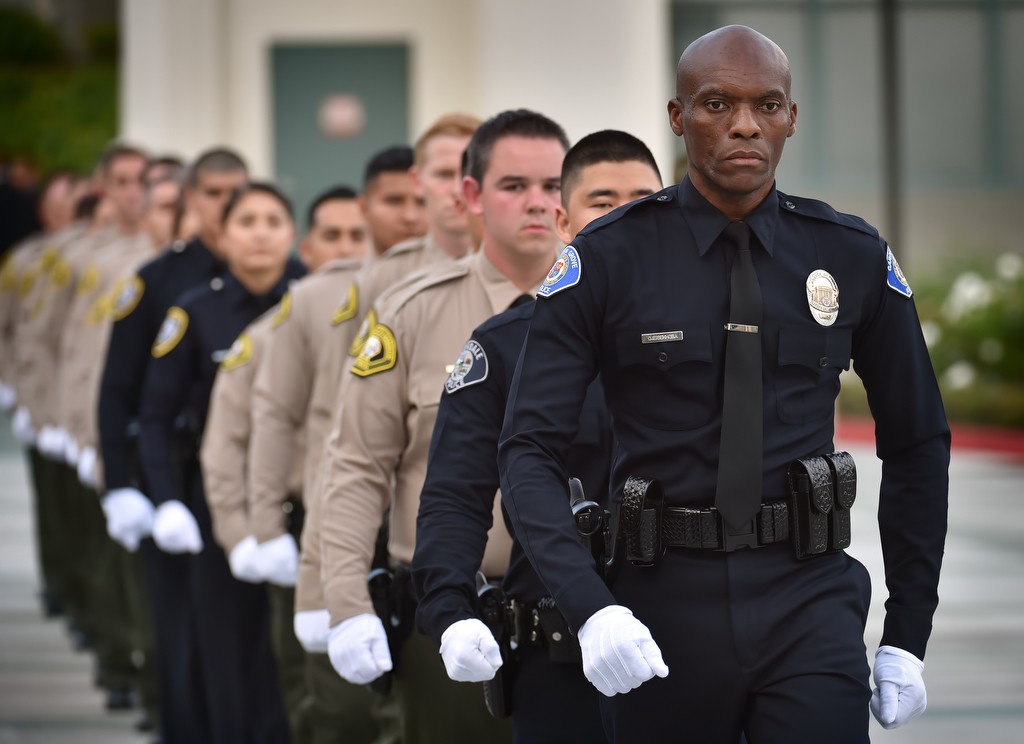 Garden Grove PD Reserve Officer John Ojeisekhoba leads his class, and two additional academy classes, into a combined LASD academy graduation ceremony.  Photo by Steven Georges/Behind the Badge OC