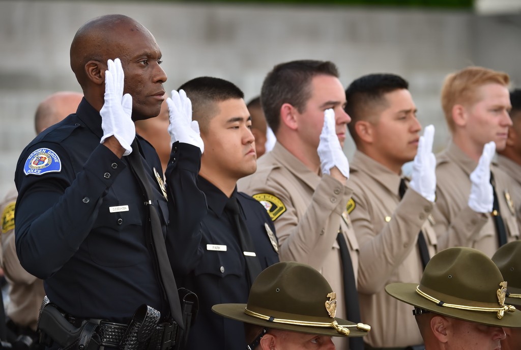 Garden Grove PD Reserve Officer John Ojeisekhoba, left, takes the oath with the rest of his LASD Level 1 academy class during a graduation ceremony at the LA Sheriff Department's Biscailuz Training Academy. Photo by Steven Georges/Behind the Badge OC
