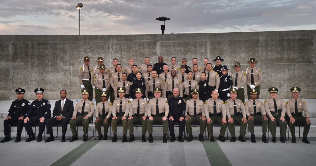 The LA Sheriff Department’s Biscailuz Training Academy graduating class that includes Garden Grove PD Reserve Officer John Ojeisekhoba, back row center, Los Angeles County Sheriff Jim McDonnell, front row center, and Garden Grove PD Captain Kevin Boddy, front row far right. Photo by Steven Georges/Behind the Badge OC