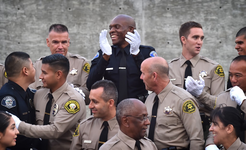 Garden Grove PD Reserve Officer John Ojeisekhoba gives a big smile at the end of LASD graduation ceremonies. Photo by Steven Georges/Behind the Badge OC