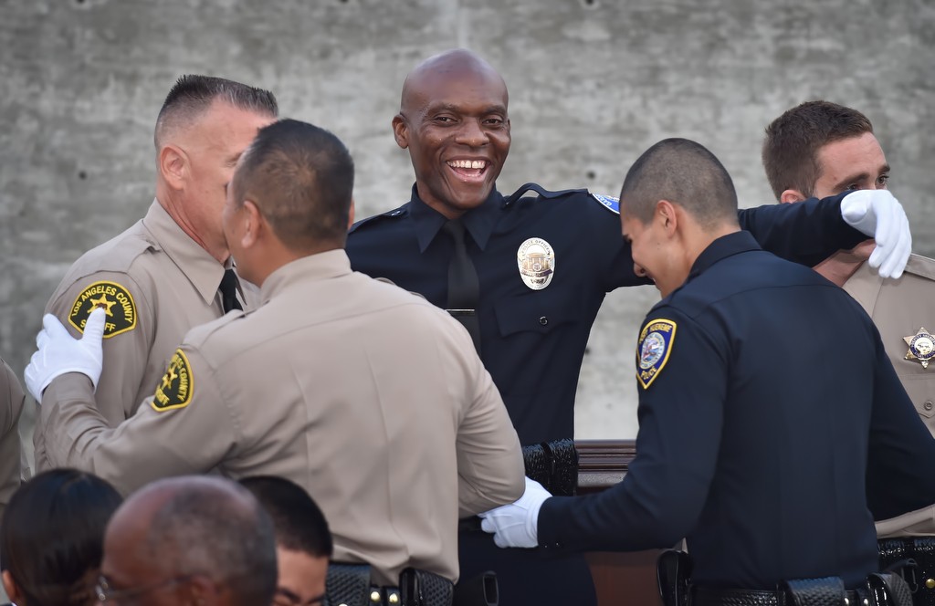 Garden Grove PD Reserve Officer John Ojeisekhoba congratulates his classmates at the end of LASD graduation ceremonies. Photo by Steven Georges/Behind the Badge OC