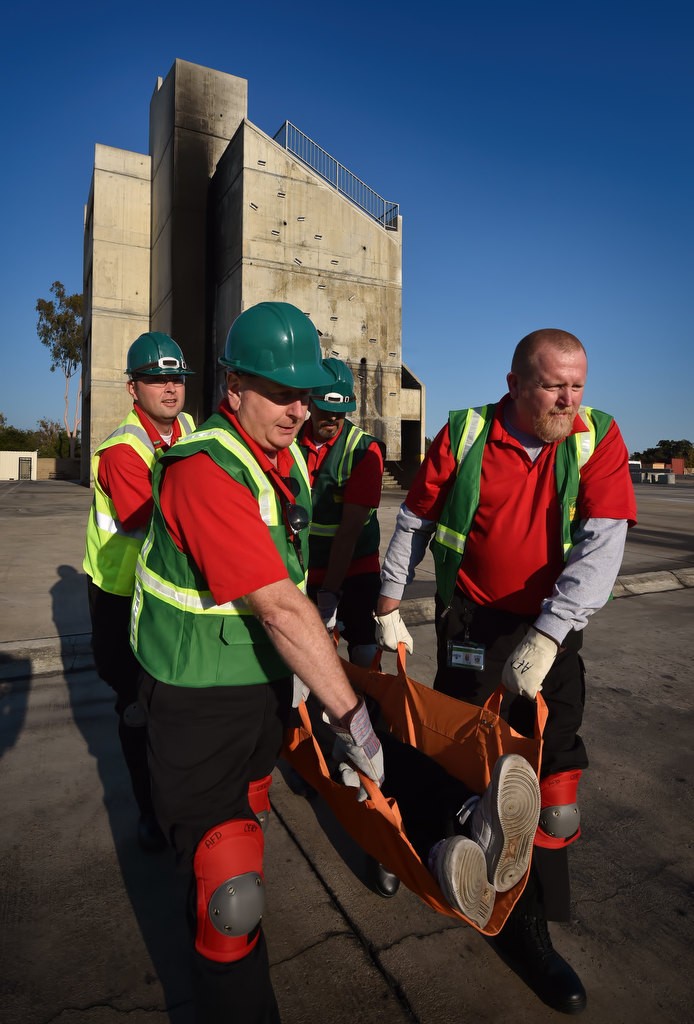 Anaheim CERT volunteers Michael Morrison, left, Neil Smith, John Thatcher and Timothy Heckerman carry victim during a search and rescue drill at Anaheim’s North Net Training Center. Photo by Steven Georges/Behind the Badge OC
