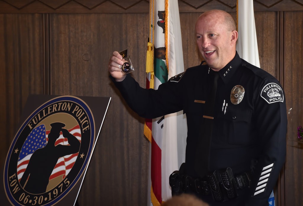 Fullerton PD Chief Dan Hughes introduces a Fullerton PD challenge coin to honor Officer Jerry Hatch, the first Fullerton PD officer to be killed in the line of duty, during a remembrance gathering. Photo by Steven Georges/Behind the Badge OC
