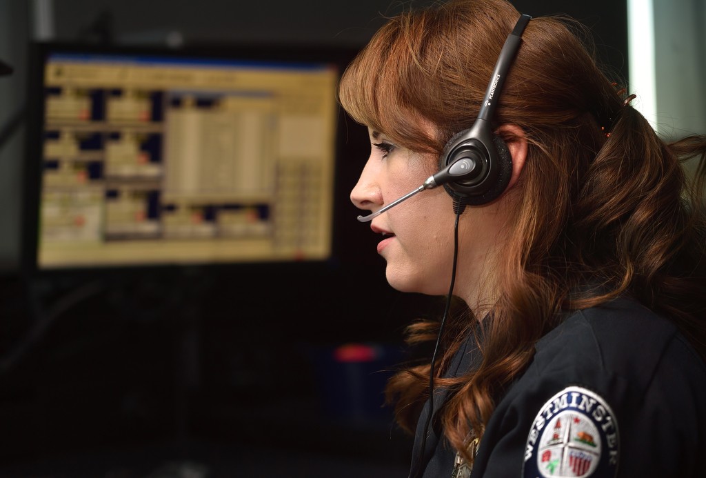 Dispatcher Roxanne Hovde of the Westminster PD takes 911 calls from the public. Photo by Steven Georges/Behind the Badge OC