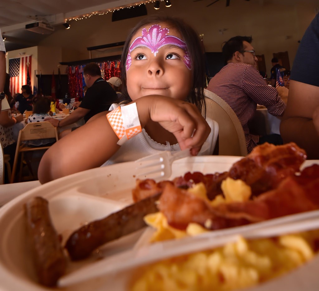 Four-year-old Galya Delrio enjoys breakfast at the American Legion Eleven-year-old Jada Meakins during a check presentation at the American Legion Newport Harbor Post 291 as part of the 4th of July Newport Harbor Cruise. Photo by Steven Georges/Behind the Badge OC