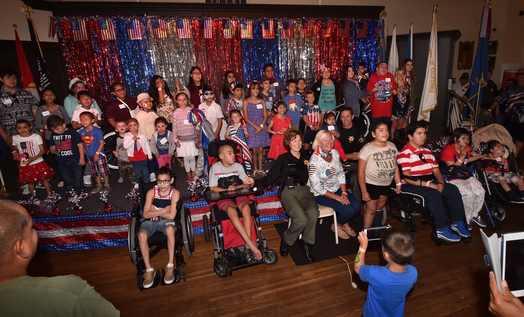 Orange County Sheriff Sandra Hutchens and Stephanie McCormick, president/CEO of Make A Wish Orange County/Inland Empire, front center, gathers with Make-a-Wish kids for photographs at the American Legion Newport Harbor Post 291. Photo by Steven Georges/Behind the Badge OC