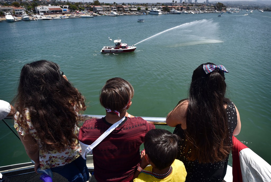 Orange County Sheriff Fire Boats entertain Make-a-Wish kids on board the Electra Cruises boat Eternity during a 4th of July Newport Harbor Cruise. Photo by Steven Georges/Behind the Badge OC