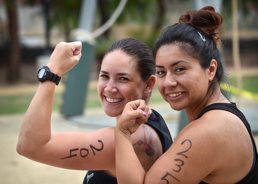 Ashley Hernandez of Anaheim, left, and Brenda Herrera of Fullerton get psyched up before the start of the OCSD Women’s Fitness Challenge. Photo by Steven Georges/Behind the Badge OC