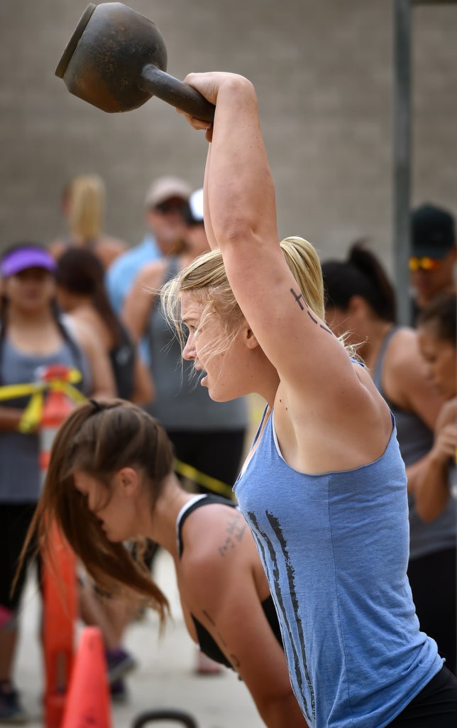 Ally Swan swings a 26 lbs weight above her head during timed competition for the OCSD Women’s Fitness Challenge. Swan would go on to take first place for Division I. Photo by Steven Georges/Behind the Badge OC