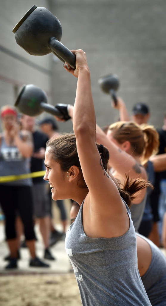 Rochelle Rivera swings a 26 lbs weight above her head during timed competition for the OCSD Women’s Fitness Challenge. Photo by Steven Georges/Behind the Badge OC