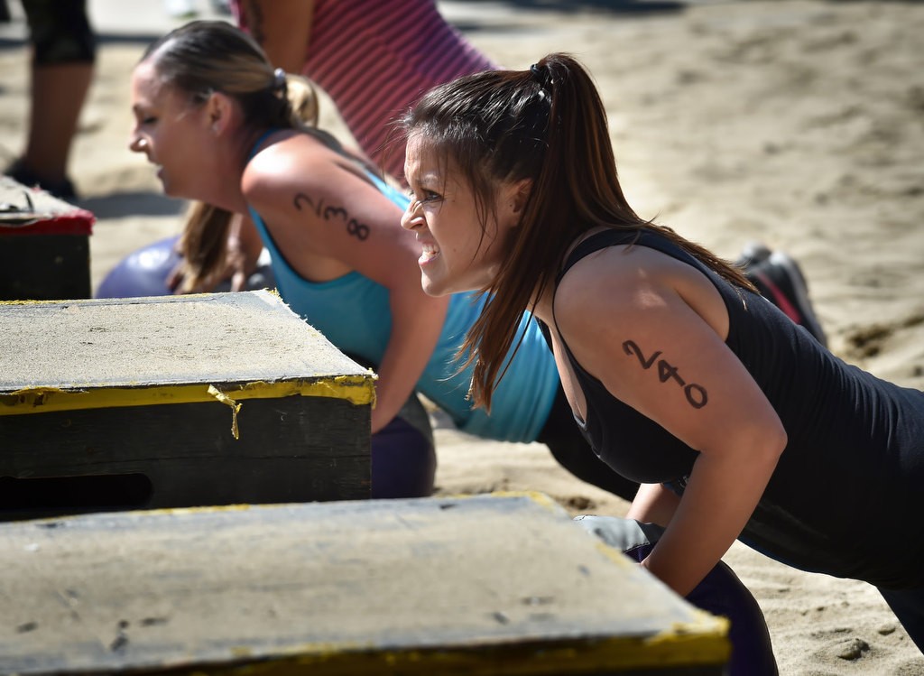Michelle Taylor, and Gabi Gomez, right, perform pushups during timed competition for the OCSD Women’s Fitness Challenge. Photo by Steven Georges/Behind the Badge OC