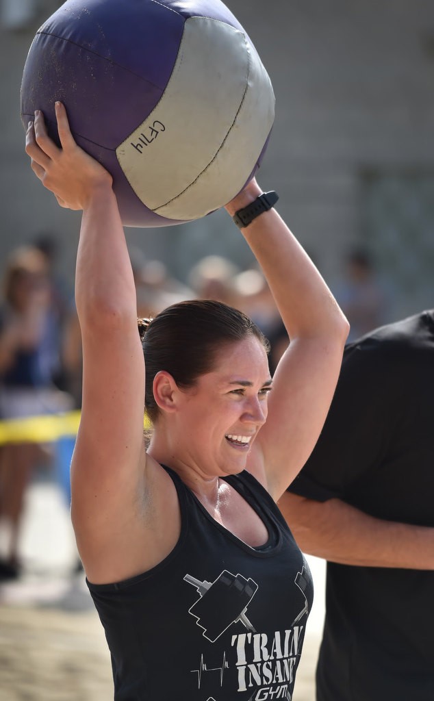 Ashley Hernandez caries a medicine ball to the next stage of a timed competition for the OCSD Women’s Fitness Challenge. Photo by Steven Georges/Behind the Badge OC