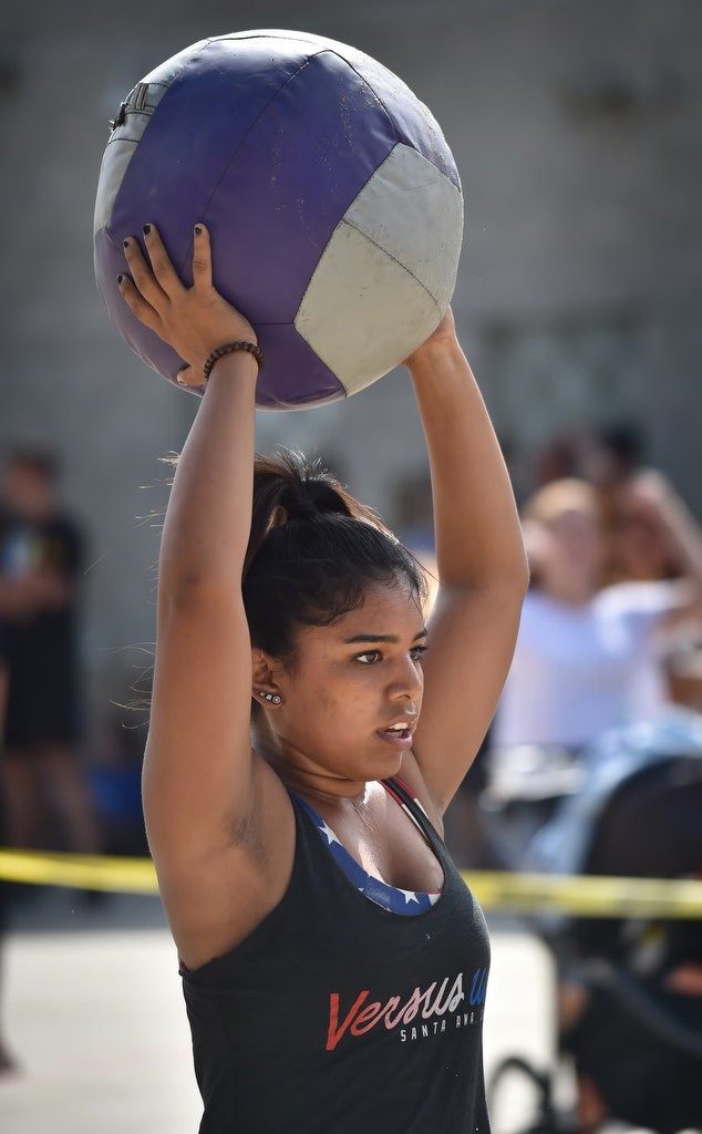 Elena Vieira caries a medicine ball to the next stage of a timed competition for the OCSD Women’s Fitness Challenge. Photo by Steven Georges/Behind the Badge OC