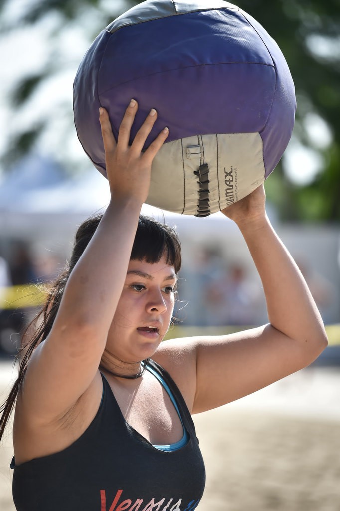 Keila Lagunes caries a medicine ball to the next stage of a timed competition for the OCSD Women’s Fitness Challenge. Photo by Steven Georges/Behind the Badge OC