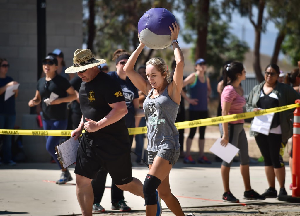 Oksana Aranskaja caries a medicine ball to the next stage of a timed competition for the OCSD Women’s Fitness Challenge. Photo by Steven Georges/Behind the Badge OC