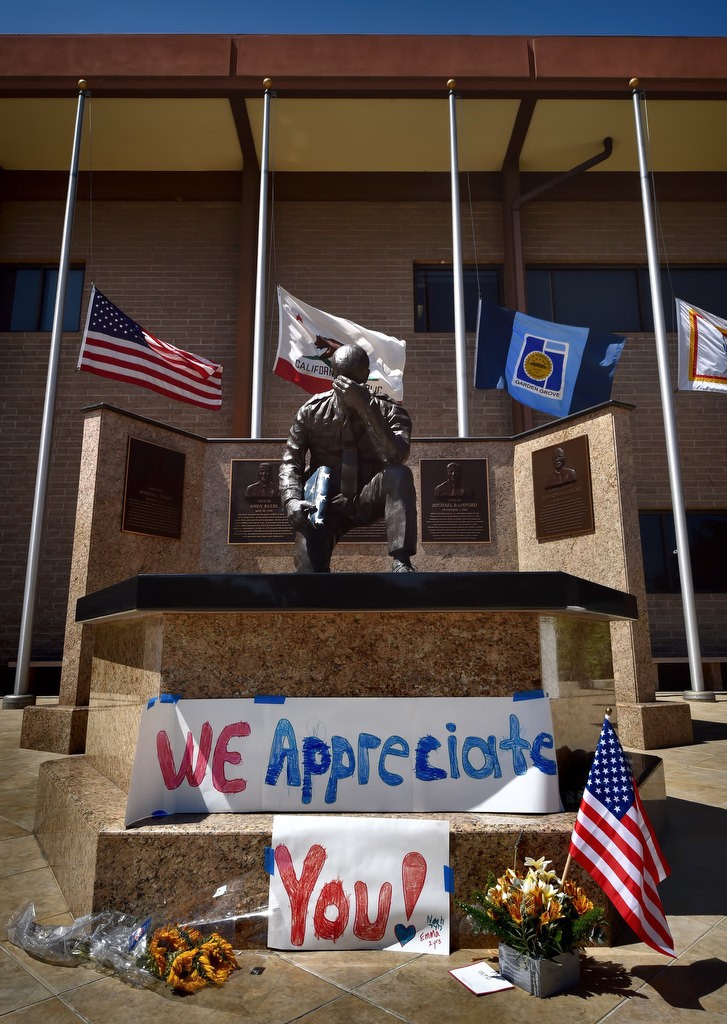 Flags fly at half-mast at the Garden Grove Police memorial where flowers, a flag and a “We Appreciate You!” banner were left. Photo by Steven Georges/Behind the Badge OC