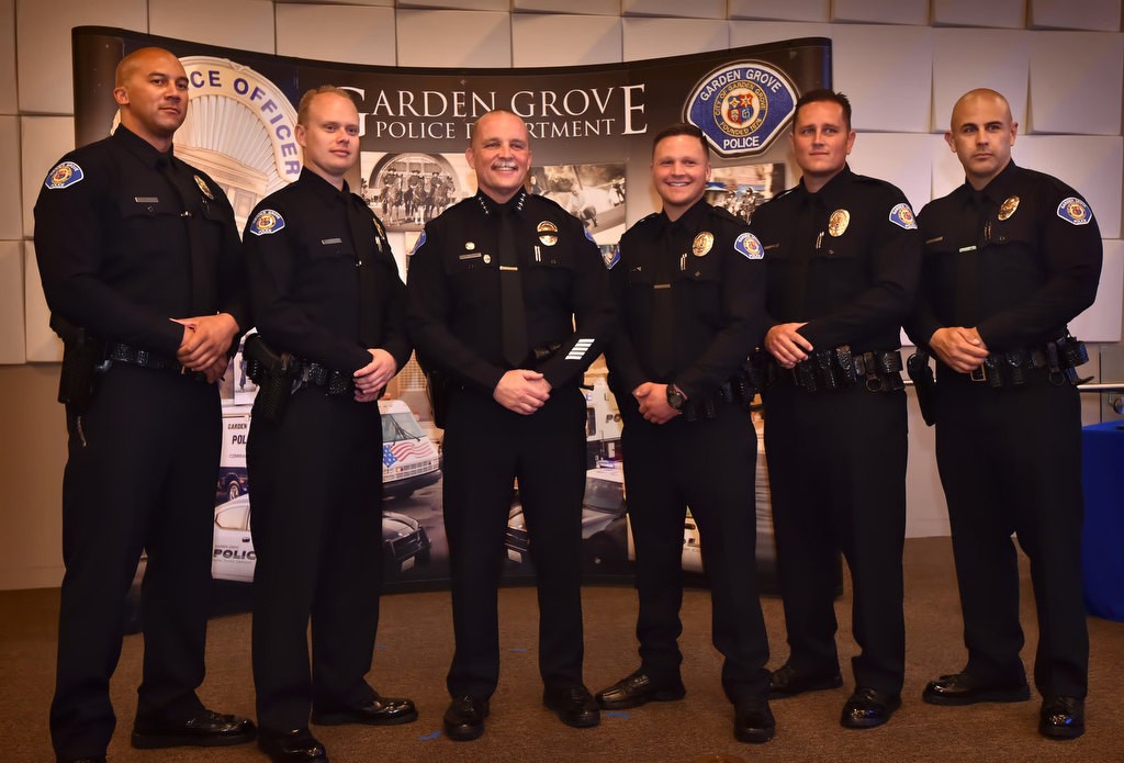 Garden Grove Police Chief Todd Elgin, center, stands with Garden Grove PD’s newest officers at the conclusion of a swearing in ceremony at the community center. They include from left, Jerome Cheatham, Timothy Ashbaugh, (Chief Elgin), Hunter King, Gary “Dustin” Staal and Arion “A.J.” Knight. Photo by Steven Georges/Behind the Badge OC