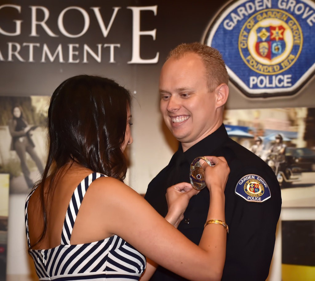 Timothy Ashbaugh, formerly Laguna Beach PD, receives his new badge as a Garden Grove PD officer during a ceremony at the community center. Photo by Steven Georges/Behind the Badge OC