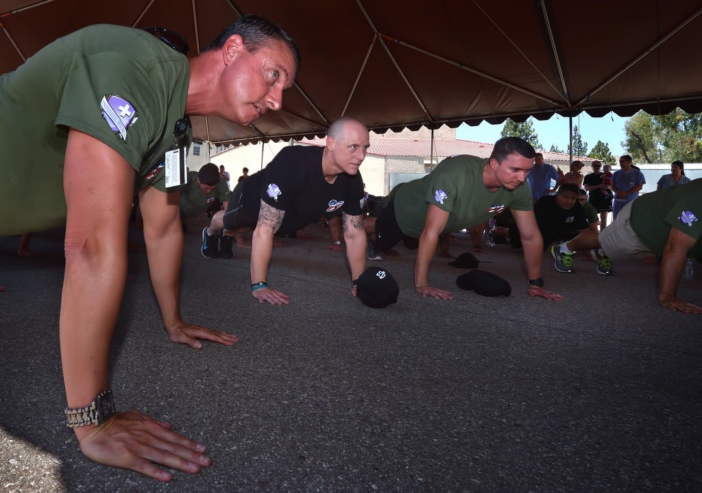 CO Sheriff Captain Jason Park, left, deputy Devin Fischer and deputy Adam Church perform the final 22 pushups during the Push 22 ceremony at the the Theo Lacy Facility. The event was to raise awareness for the 22 veterans who, on average, commit suicide each day. Photo by Steven Georges/Behind the Badge OC
