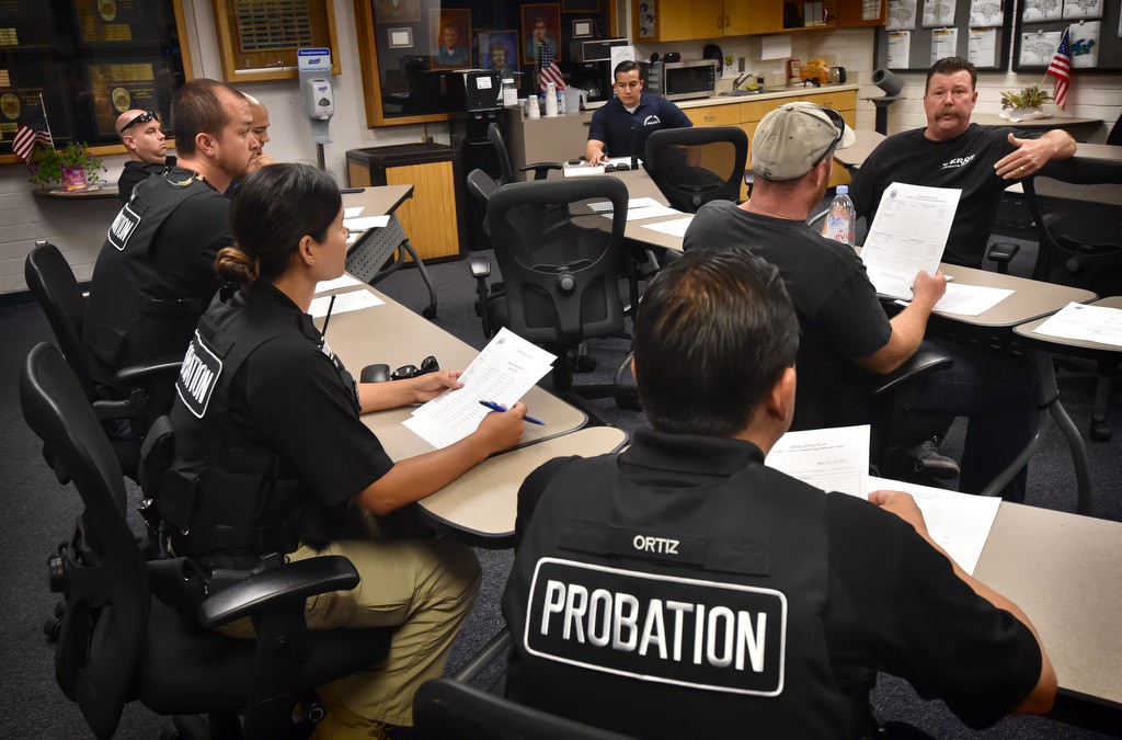 Garden Grove PD and Orange County Probation discuss the targets for the day’s operation at Garden Grove police headquarters before heading out. Photo by Steven Georges/Behind the Badge OC