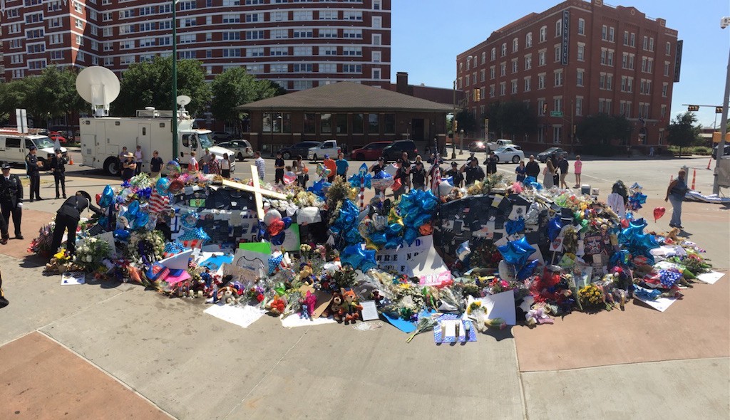 A memorial outside Dallas PD headquarters is covering with flowers, balloons and notes paying respects to the five fallen officers killed in a targeted attack July 7. Photo courtesy Tustin PD. 