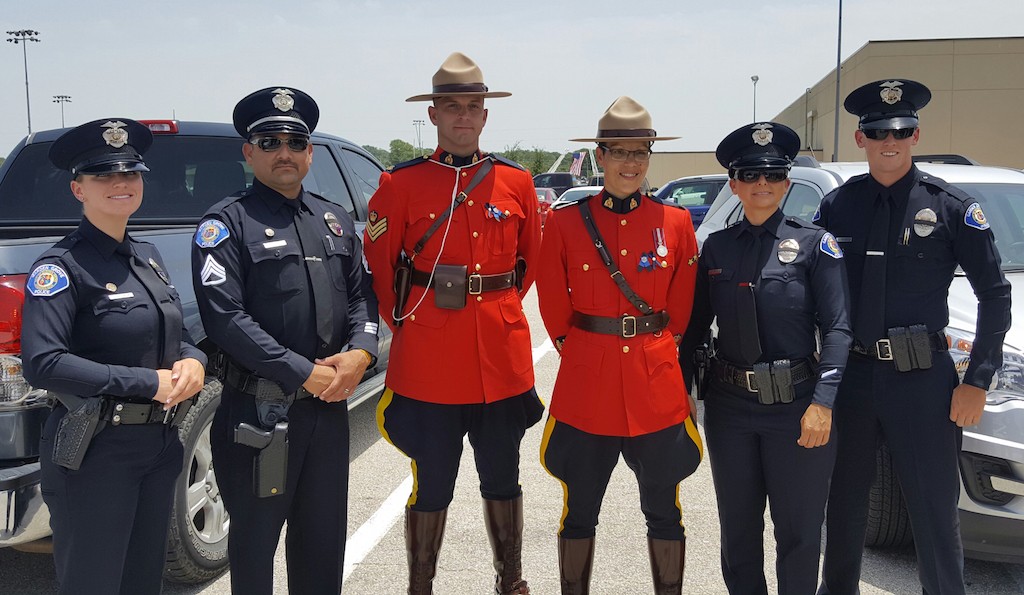 From left: Garden Grove PD Officer Vanessa Brodeur,  Sgt. Rich Burillo, Officer  Claudia Alarcon and Officer Austin Laverty pose with two members of the Canadian police in Dallas. Eight Garden Grove officers traveled to Texas to pay respects to the five officers killed in targeted attacks July 7. Photo courtesy Garden Grove PD. 