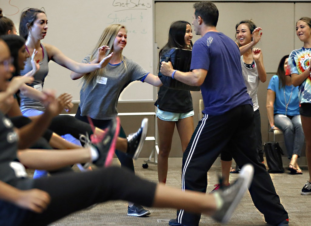 Katie Lafetra practices self-defense moves against instructor Stuart Haskin during a female empowerment initiative safety training session at Laguna Niguel City Hall. Photo by Christine Cotter/Behind the Badge OC 