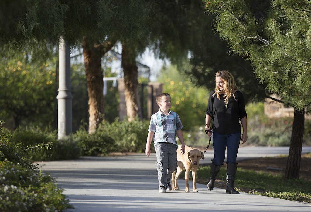 Orange County Sheriff's Deputy Sarah Pavuk walks with her son. She said her 6-year-old was her motivation for making it through the academy two years ago. She now works at the Intake Release Center in Santa Ana. Photo courtesy the Orange County Sheriff's Department. 
