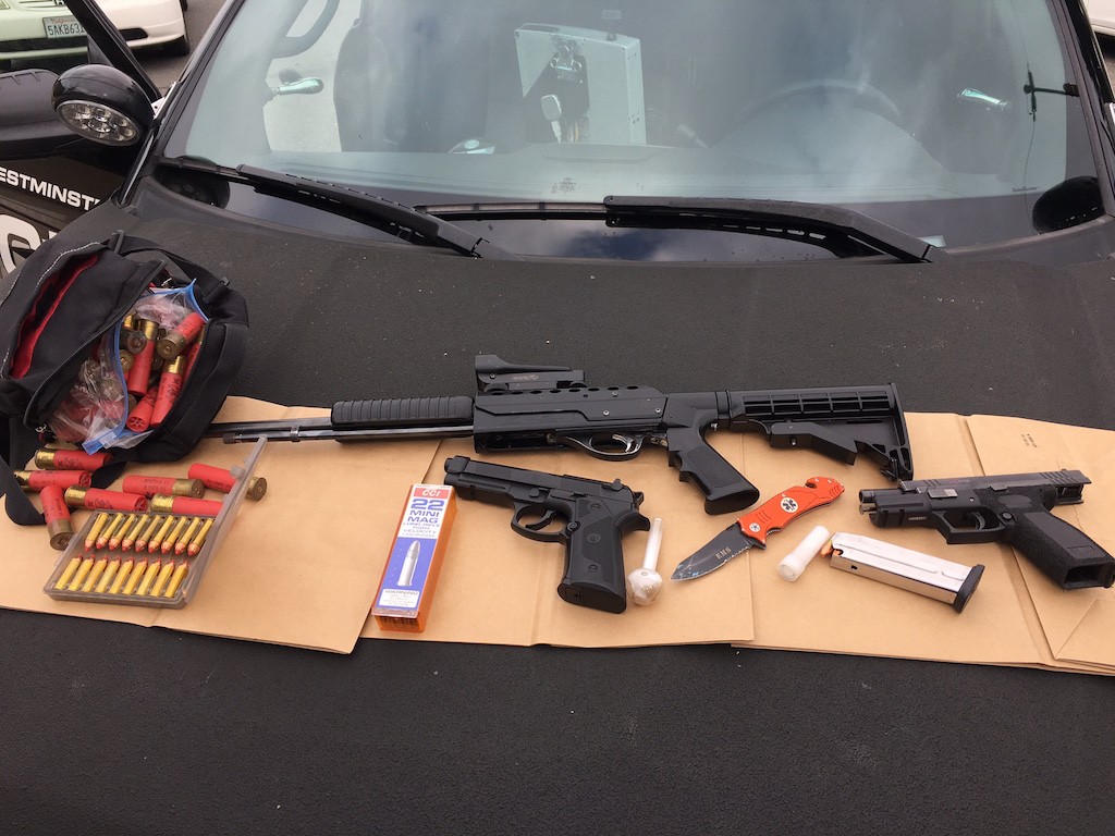 Police recovered a 9 mm handgun stuffed between the driver’s seat and center console, a modified .22 caliber rifle and a replica 9 mm BB gun, along with hundreds of rounds of ammunition, during a suspicious vehicle investigation.  Photo courtesy the Westminster PD. 