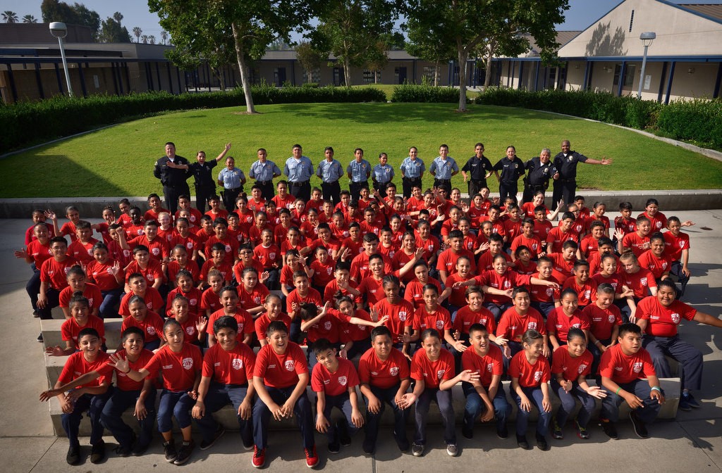 The 2016 Anaheim PD Cops 4 Kids Jr. Cadet Academy, advance class, at Betsy Ross Elementary. Light blue shirts in back row are Explorers. Photo by Steven Georges/Behind the Badge OC
