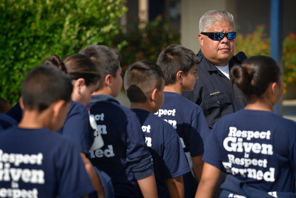 Anaheim PD Officer Ed Arevalo with cadets during the 2016 Anaheim PD Cops 4 Kids Jr. Cadet Academy. Photo by Steven Georges/Behind the Badge OC
