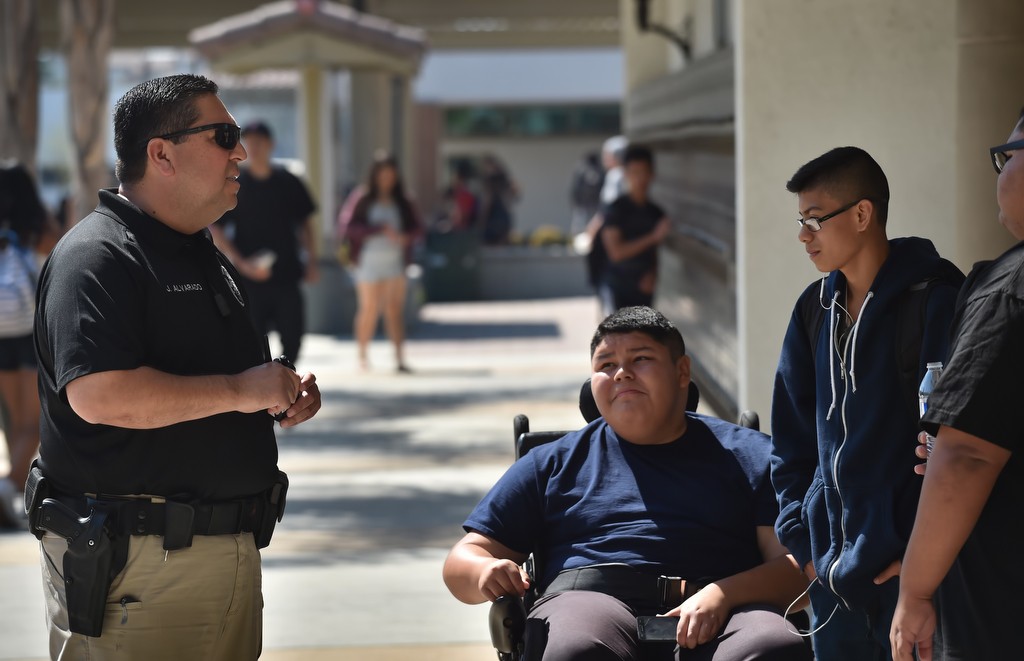 Tustin PD Officer John Alvarado, who is retiring as the city's school resource officer, walks through the Tustin High School campus. Photo by Steven Georges/Behind the Badge OC