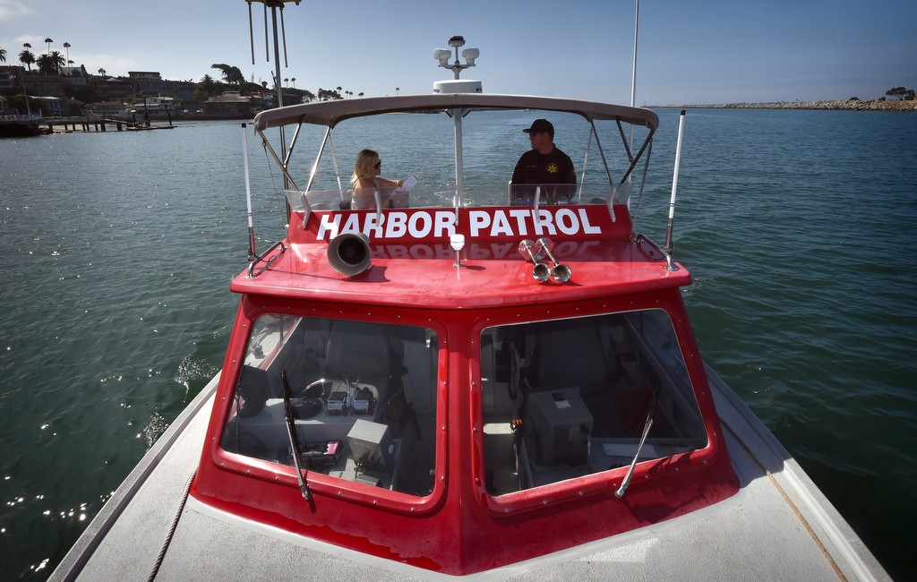 Orange County Sheriff Mooring Administrator and Accident Investigator Kevin Webster, right, patrols Newport Harbor with Behind the Badge reporter Jaimee Lynn Fletcher. Photo by Steven Georges/Behind the Badge OC