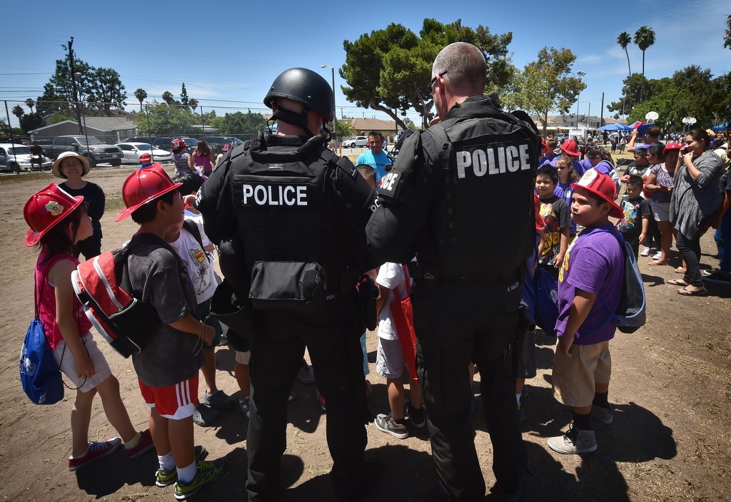 Kids gather around West County SWAT members after a demonstration at Sigler Park during Westminster’s annual Public Awareness Safety Day. Photo by Steven Georges/Behind the Badge OC