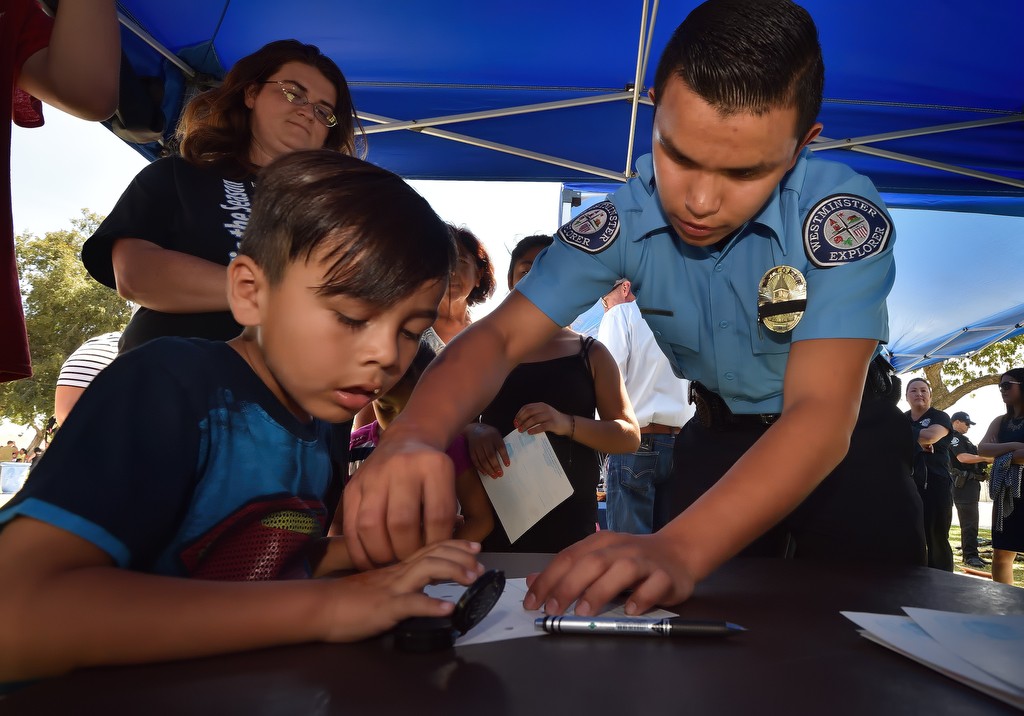 Five-year-old Santiago Hernandez of Westminster gets his fingerprints done by Westminster PD Explorer Ricardo Cazares during the City of Westminster’s annual Public Awareness Safety Day at Sigler Park. Photo by Steven Georges/Behind the Badge OC