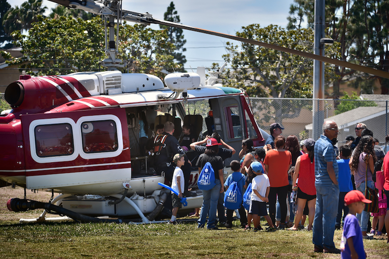 Kids line up to take a look at one of Orange County Fire Authority’s helicopters that landed at Sigler Park during Westminster’s annual Public Awareness Safety Day. Photo by Steven Georges/Behind the Badge OC