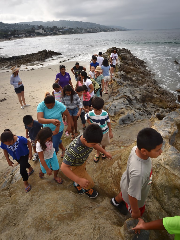 Kids walk through the tide pools at Laguna Beach during a field trip organized by the Orange County Family Justice Center Foundation. Photo by Steven Georges/Behind the Badge OC