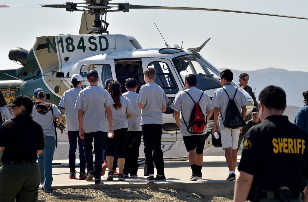 Members of the OC Sheriff Department’s Youth Citizens’ Academy walk up to OC Sheriff’s helicopter Duke 2 during a tour at Loma Ridge. Photo by Steven Georges/Behind the Badge OC