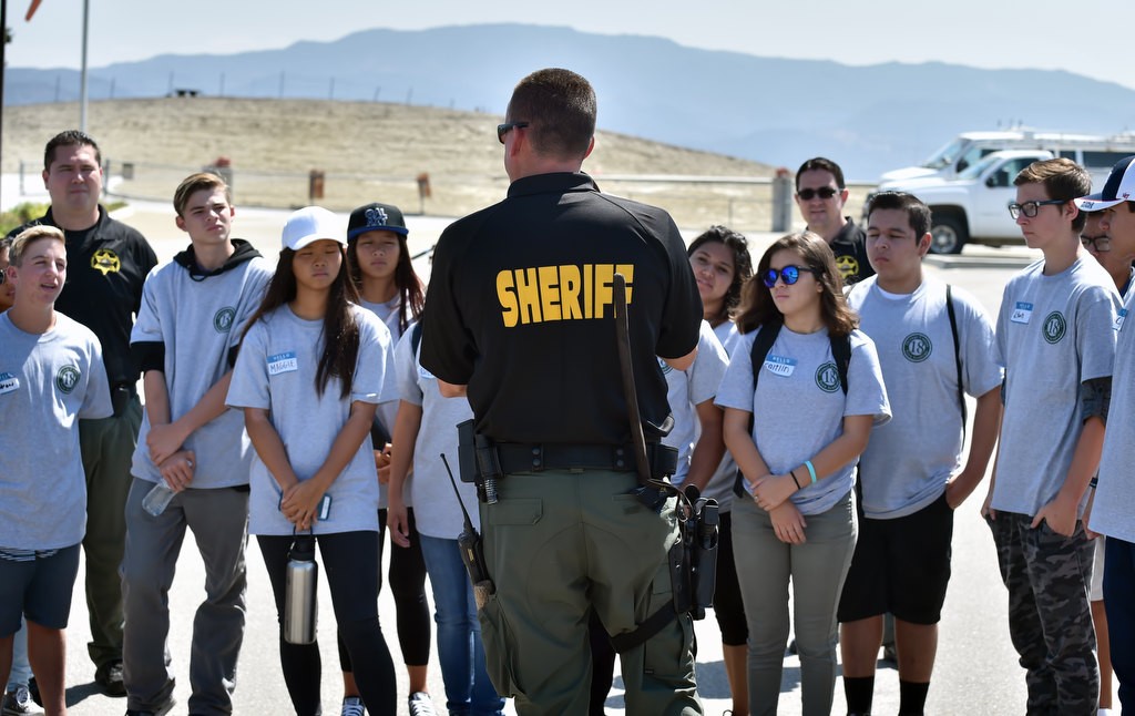 OC Sheriff Deputy Ryan Buhr talks to kids from the Orange County Sheriff Youth Citizens’ Academy about the K-9 department during a tour at Loma Ridge. Photo by Steven Georges/Behind the Badge OC