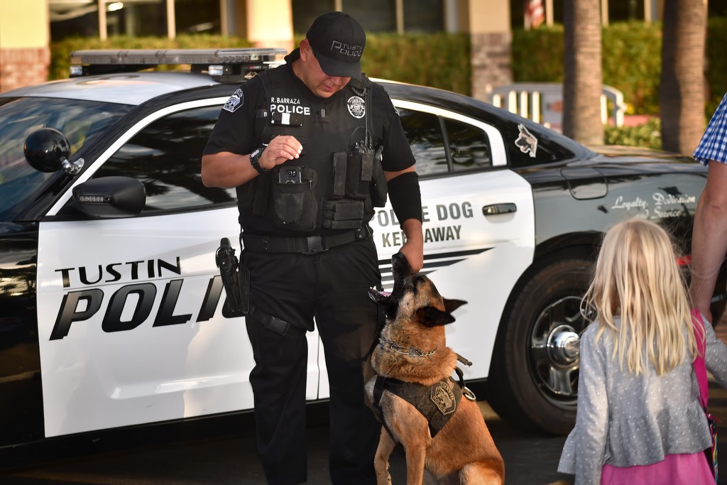 Tustin PD Officer Rene Barraza shows off his K-9 partner Bravo as kids gather to watch during Tustin PD’s National Night Out. Photo by Steven Georges/Behind the Badge OC