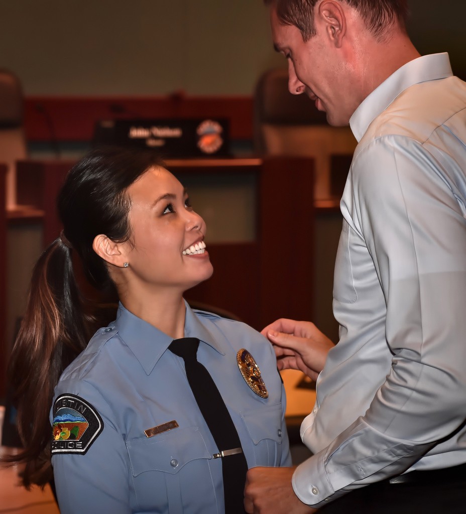 Tustin Police Records Specialist Eileen Chen has her badge pinned to her by her boyfriend, Brett, during a promotions and swearing in ceremony. Photo by Steven Georges/Behind the Badge OC